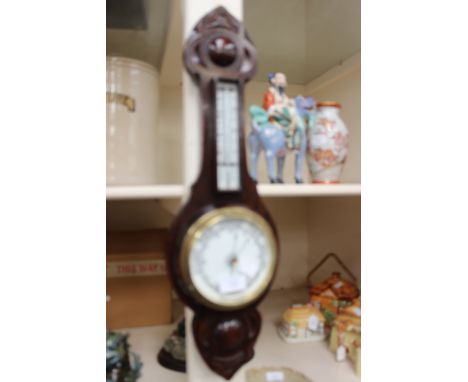 A carved oak cased Edwardian aneroid barometer (English)