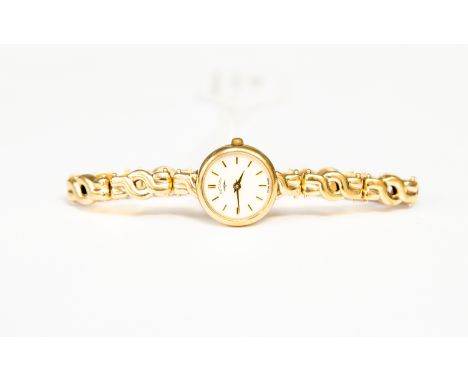 A 9ct gold  ladies Rotary watch, round dial, batons, cream enamel dial, approx diameter 15mm, 9ct gold strap,  total gross we