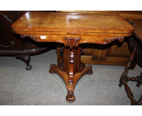 An early Victorian oak and burr walnut cross-banded pedestal fold-over card table, carved column, triform base