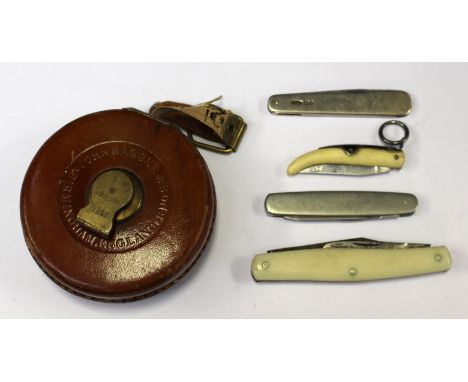 A collection of pen knives, one silver ivory and bone, along with mid 20th Century tape measure 