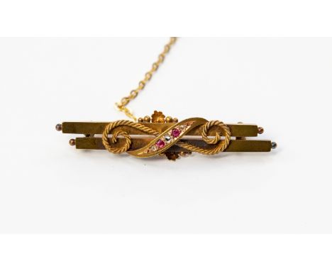 A 15ct gold bar brooch, set with diamond and ruby chips (boxed)