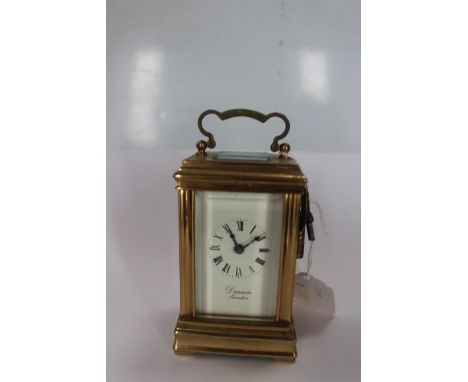 A miniature brass cases carriage clock, the dial inscribed 'Deacon Swindon' with Roman numerals 
