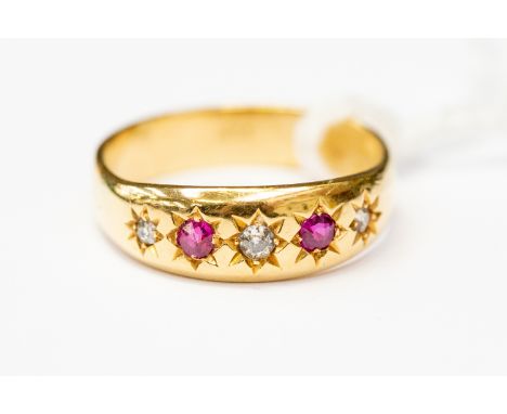 A ruby and diamond ring, star set with two rubies and three small diamonds, 18ct gold mount, size P, total gross weight appro