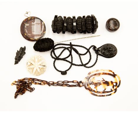 A tortoiseshell pendant and chain, Japanese jet brooch along with a carved jet type pendant and bracelet, a tortoiseshell pil