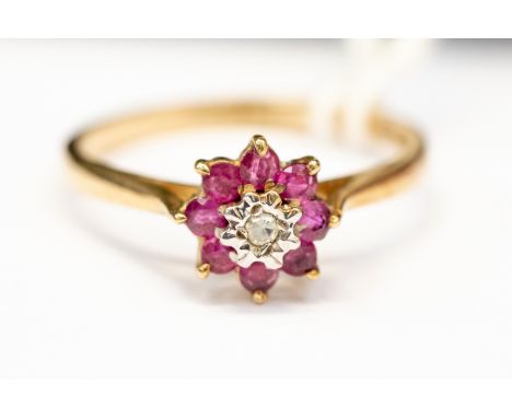 A 9ct gold ruby and diamond flower head cluster ring , size N, total gross weight approx 1.9gms