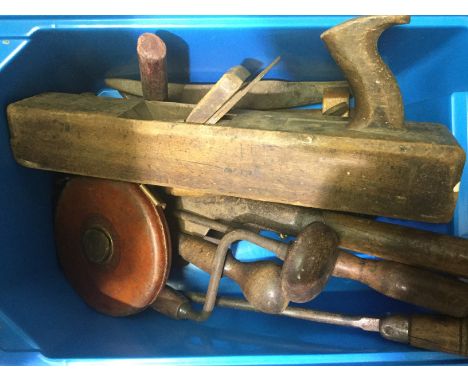A collection of wood working and agricultural tools, bill hooks, leather case Rabone tape measure, large wooden plane, etc.