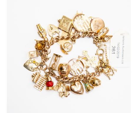 A 9ct gold charm bracelet, with 9ct and unmarked yellow metal charms, including heart, egg timer, some Arabic interest, paint