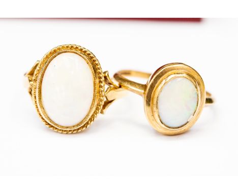  Two 9ct. yellow gold and opal rings, both set oval cabochon opal and hallmarked for 9 carat gold to shank, (total gross weig