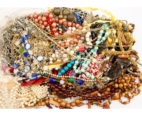 A collection of costume jewellery to include wooden bead necklaces, agate necklace, faux pearls, glass bead strands, gilt met