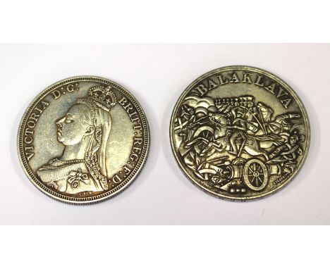 A Replica 1854 Balaklava medallion. The obverse illustrates Lord Cardigan leading a line of Lancers over the Russian cannon, 