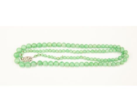 A Nephrite jade Art Deco bead necklace, graduated round beads with diamond set 14ct gold and platinum clasp, length approx 29