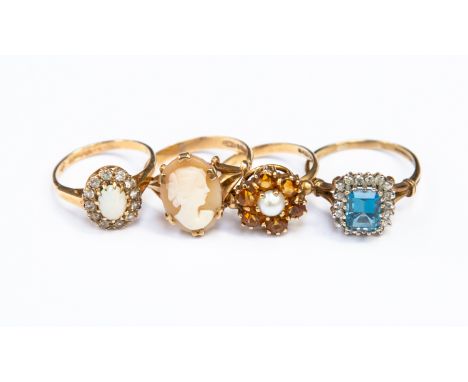 Four 9ct gold vintage stone set rings, including a blue stone set cluster, an opal and white stone version, a cameo ring and 