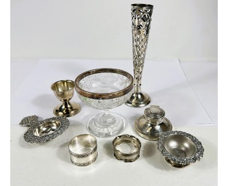 A hallmarked silver overlaid specimen vase; a pedestal dish with silver rim; a silver capstan inkwell; a tea strainer; etc., 