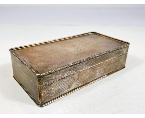 A hallmarked silver rectangular cigarette box with engine turning, Birmingham 1926