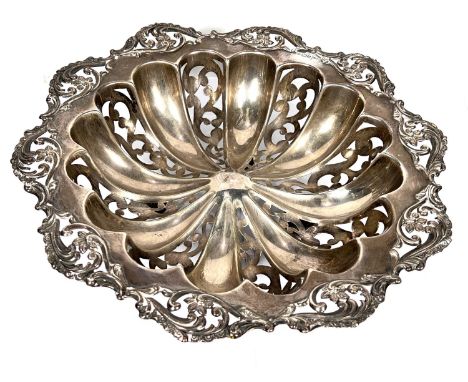 A hallmarked silver circular dish, ribbed and pierced with floral border, on 4 ball feet, Sheffield 1905, diameter 27cm, 11.7