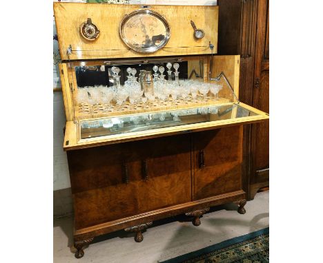 A large Art Deco burr walnut drinks cabinet with fall front, fitted interior with glassware 3 drawers below, and cupboards on