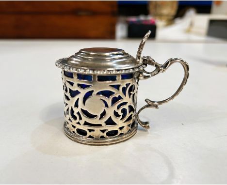 An Irish hall marked Silver mustard pot with pierced decoration and hinged lid, Dublin 1932 Bristol blue glass liner 