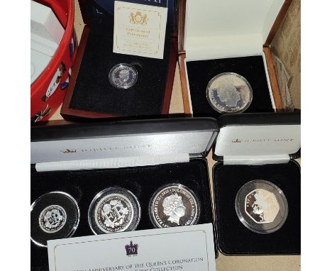 SOLOMON ISLANDS - $1, $ &amp; $5 set fine silver,&nbsp; an IOM silver proof £1, a £5 Britannia 2009 and silver 50 pence (Tris