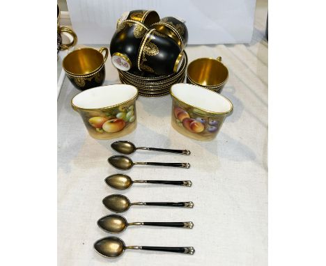 A Royal Worcester set of 6 cabinet cups and saucers with gilt decoration against a black ground; a set of 6 similar enamelled