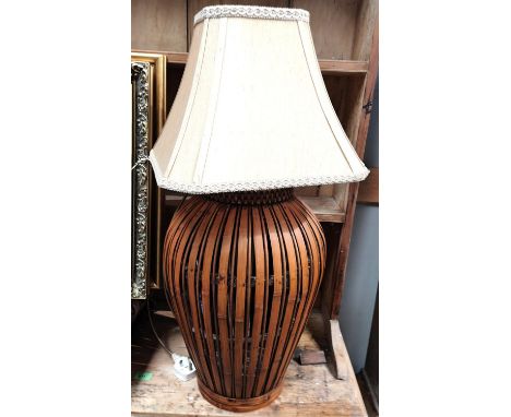 An unusual bamboo basket lamp and a stained wood standard lamp 