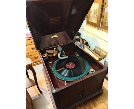 A mahogany cased HMV E. Rasin Jones Ltd record player with extra needles 