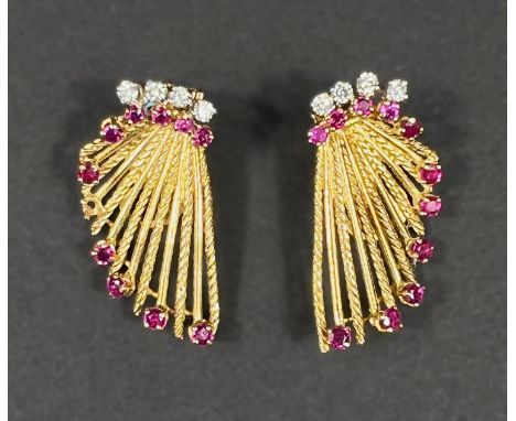 A pair of 1970's 18ct hallmarked gold fan shaped clip on earrings each stick set with a ruby and with a band of 4 diamonds to