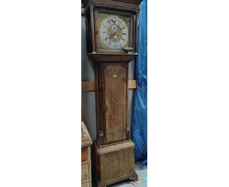 An 18th century oak and mahogany long case clock with cross banded decoration, having caddy top hood with turned Corinthian c