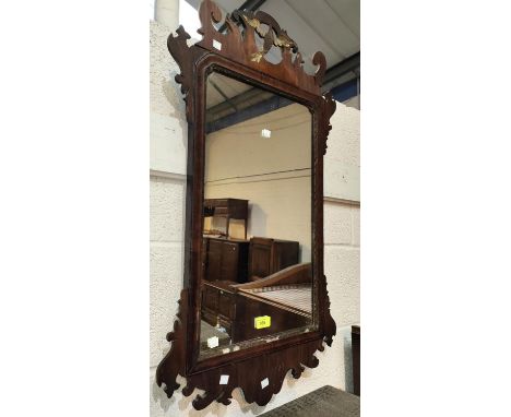 A Chippendale style wall mirror in parcel gilt and fretwork frame 