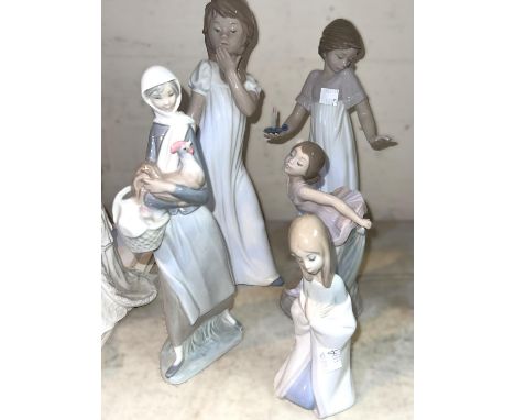 Three Nao figures, ballerina, yawning girl, girl with candle and two Lladro figures 