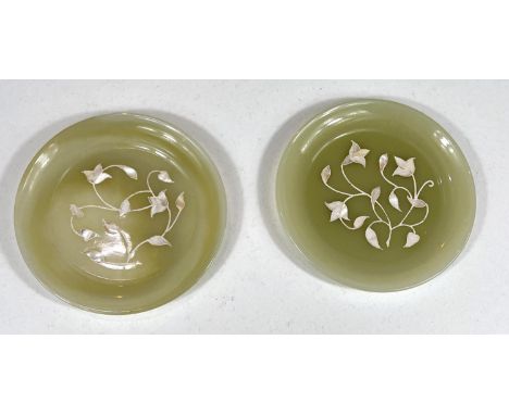 Two Chinese jade coloured dishes with inlaid mother of pearl decoration, dia. 15cm; a Chinese calligraphy set framed 