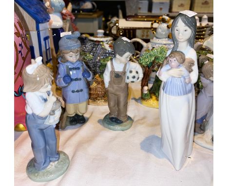 Four Nao porcelain figures:&nbsp; 2 girls with dolls; boy with football; girl with dog dressed for hiking 