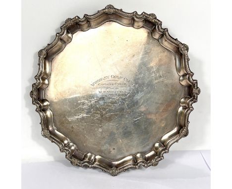 A hallmarked silver salver with scalloped shell border and scroll feet, inscribed, Birmingham 1935, diameter 30cm, 27oz