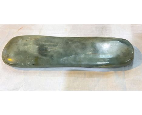 A Chinese 17th/18th century jade rounded rectangular scholars wrist rest, length 39cm 
