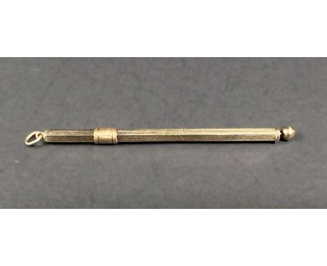 A 9 carat hallmarked gold cocktail stick, retractable with swivel stick, engine turned, 6gm 