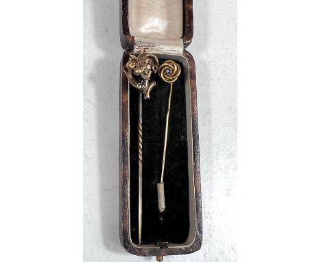 Two yellow metal stick pins, one with stone, one with branch and leaf, both test approx. 14ct, 5.6gm 