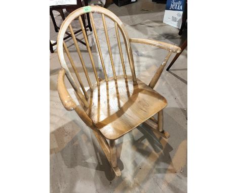 An Ercol light wood stick back rocking chair; a pine chair and stool 