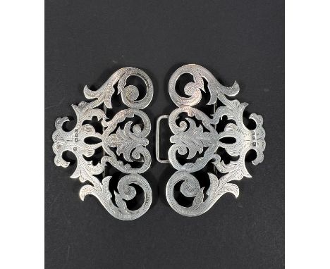 A hallmarked silver nurse's buckle with ornate chased decoration 