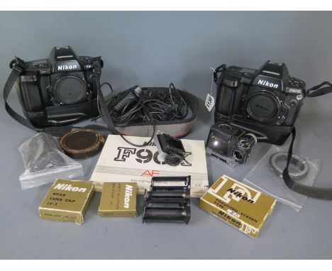 A collection of Nikon camera equipment to include two Nikon F90X film cameras with power grips and extra battery holders, Mik