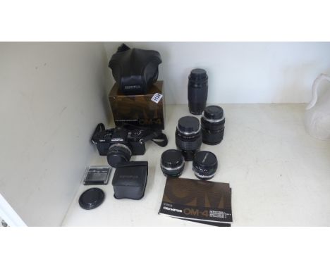 An Olympus OM4 camera with five additional lenses and a flash - boxed