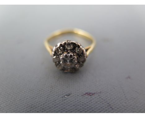 An 18ct yellow gold and diamond cluster ring, the central diamond approx 0.25ct surrounded by eight smaller diamonds - ring s