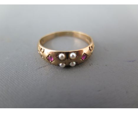 A 9ct yellow gold pearl and ruby ring - approx weight 2.9 grams - ring size S - light surface wear, surface scratches