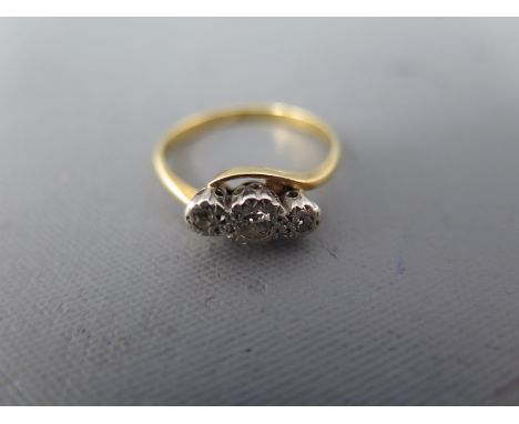 An 18ct yellow gold and three stone diamond ring size K - approx weight 2.6 grams - light surface scratches