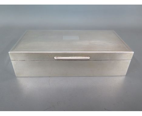 A silver hallmarked cigarette box with engine turned finish to top London 1955/56