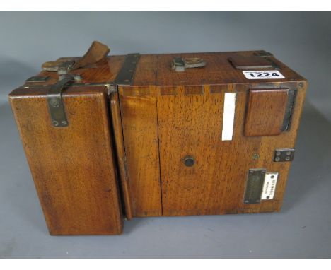 A late 19th century Steinheil plate camera with variable aperture and clockwork exposure in a mahogany case, rear door opens 