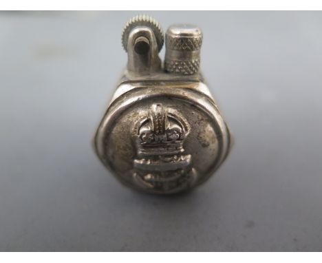A white metal pocket lighter with Royal Naval emblem