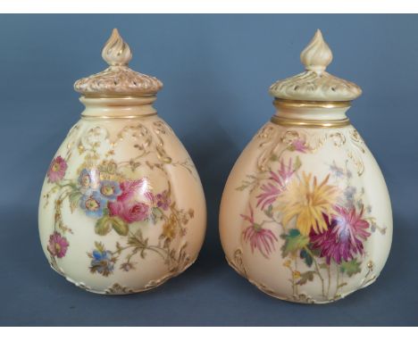A pair of Worcester blush ground vases and covers decorated with floral designs and gilt highlighted - one vase missing inter