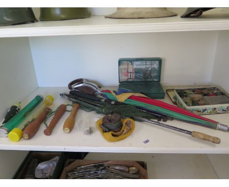 An assortment of vintage fishing tackle to include a large wooden tackle box, reels, umbrella shooting stick and a Hardy trou