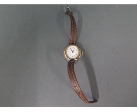 A silver cased Ladies wristwatch on leather strap, Arabic numerals to white enamel dialCondition report: Not running 