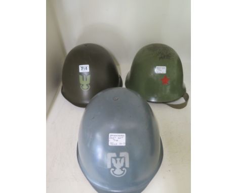 Two Polish M75 helmets post 1975 one with Army Eagle the second Air Force and Yugoslavian M59 helmet with Communist Red Star