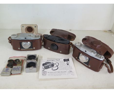 A collection of three different models of the British made Purma cameras, together with some scarce accessories to include th